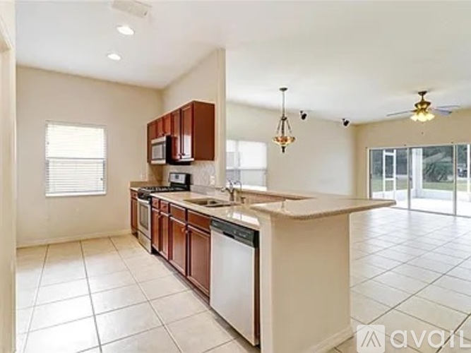 A kitchen with brown cabinets and a white countertop.