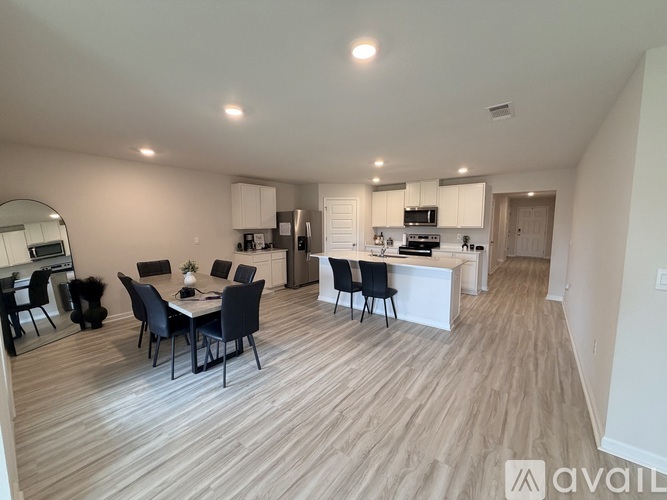 A modern kitchen with a dining table and chairs.