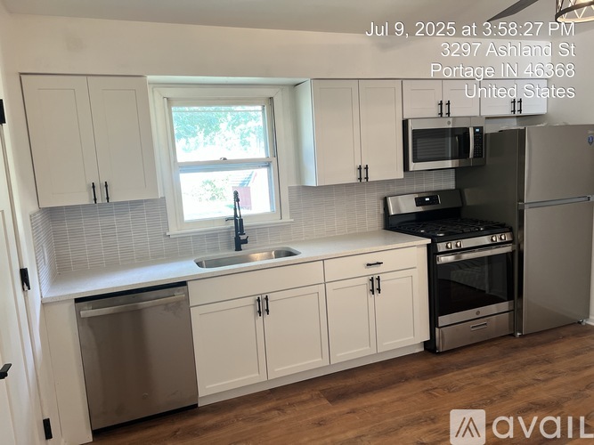 A kitchen with white cabinets and stainless steel appliances.