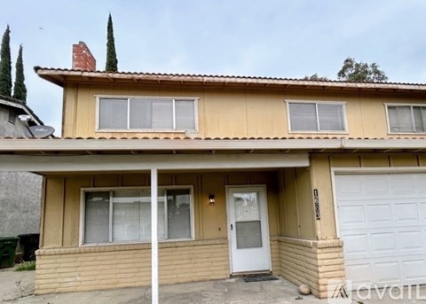 A house with a white door and windows is for sale.