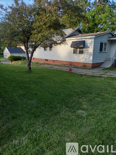 A house with a tree in front of it.