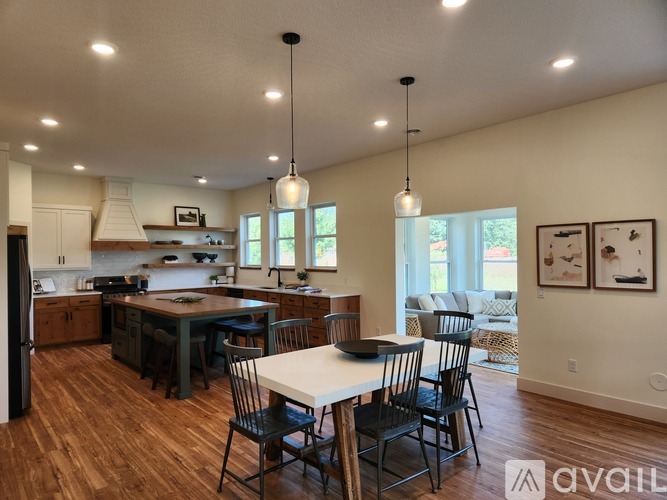 A modern kitchen with a dining table and chairs.