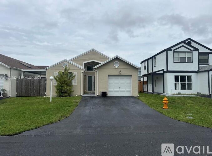 A house with a driveway and a garage door.