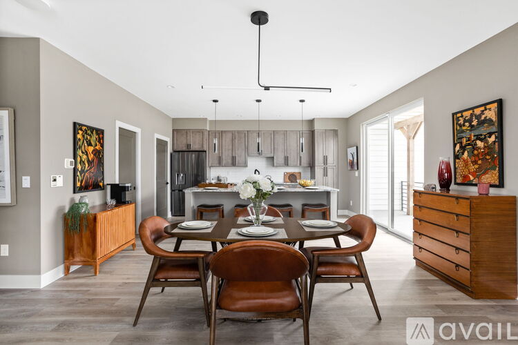 A modern dining room with a wooden table and chairs.