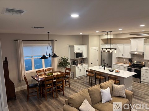 A well-lit kitchen and dining area with a table set for a meal.