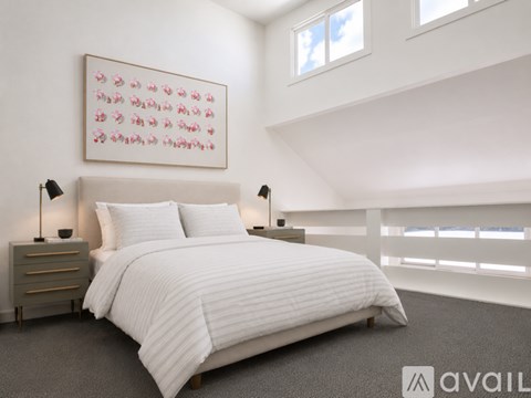 A bedroom with a large bed, two lamps, and a painting on the wall.