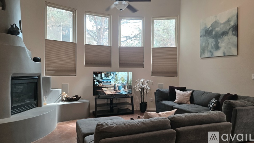 A living room with a grey couch and a television.