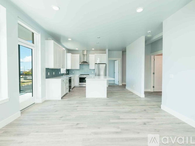 A spacious kitchen with white cabinets and a large island.