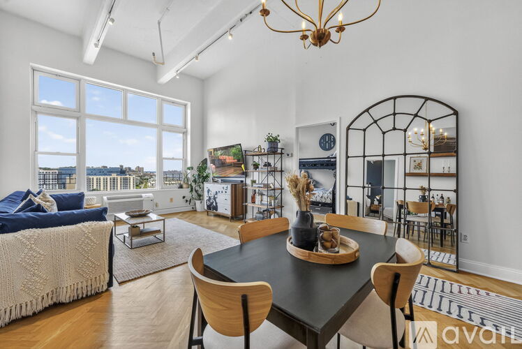A dining room with a table set for four and a view of the city.