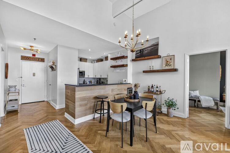 A modern kitchen with a dining table set up with chairs.