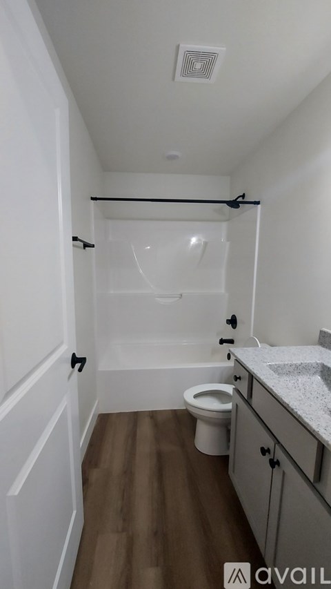 A small bathroom with a toilet, sink, and bathtub.