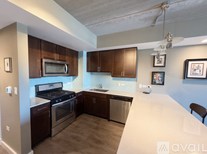 A kitchen with brown cabinets and a white countertop.