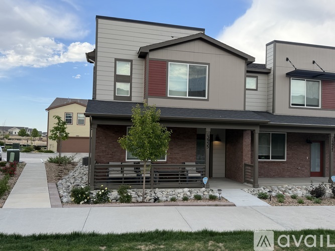 A modern house with a front yard and a sign that says "available".
