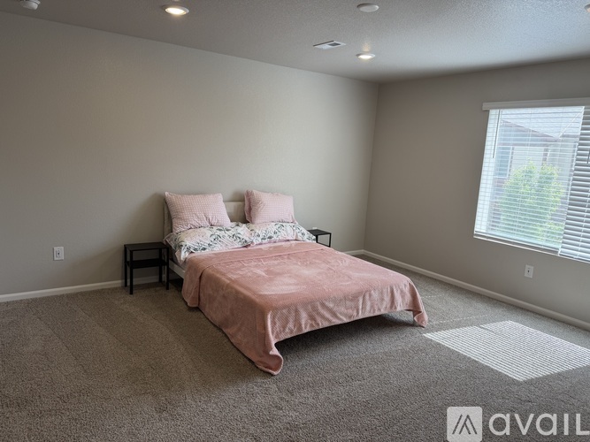 A bedroom with a bed and two pillows.