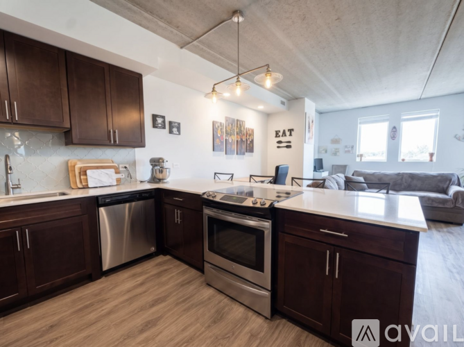 A kitchen with dark wood cabinets and stainless steel appliances.