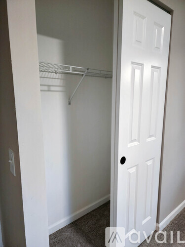 A white door with a small hole in the bottom right corner.