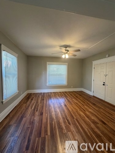 A room with wooden floors and a ceiling fan.