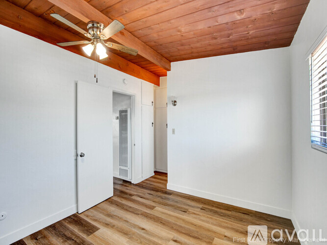 A room with wooden floors and a ceiling fan.