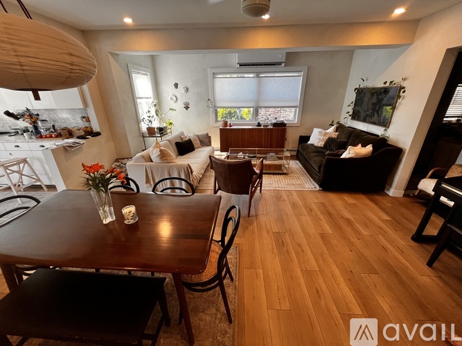 A living room with a brown table and chairs.