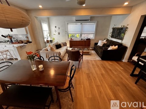 A living room with a brown table and chairs.