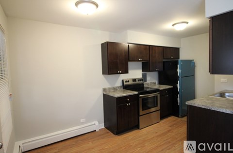 A kitchen with dark wood cabinets and stainless steel appliances.