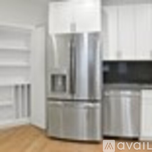 A stainless steel refrigerator in a kitchen.