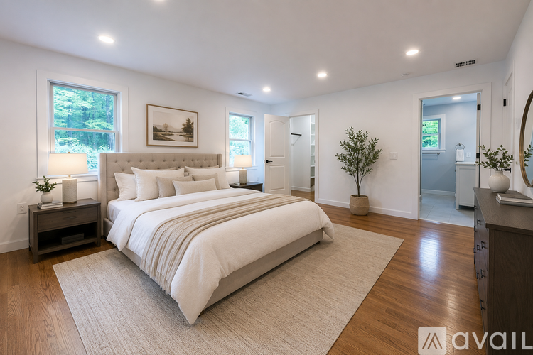 A bedroom with a large bed and a mirror on the wall.