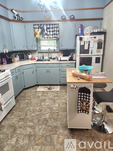 A kitchen with a blue cabinet and a white oven.
