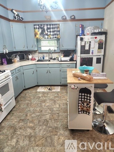 A kitchen with a blue cabinet and a white oven.