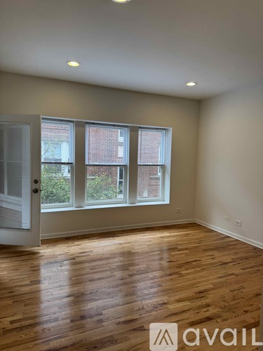A living room with a couch, coffee table, and boxes on the floor.