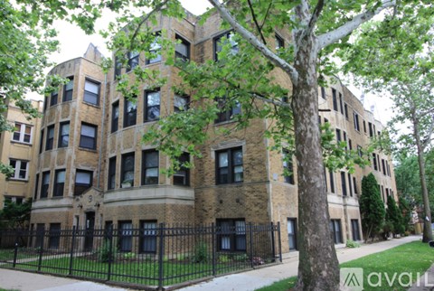 A tall building with a black fence in front of it.