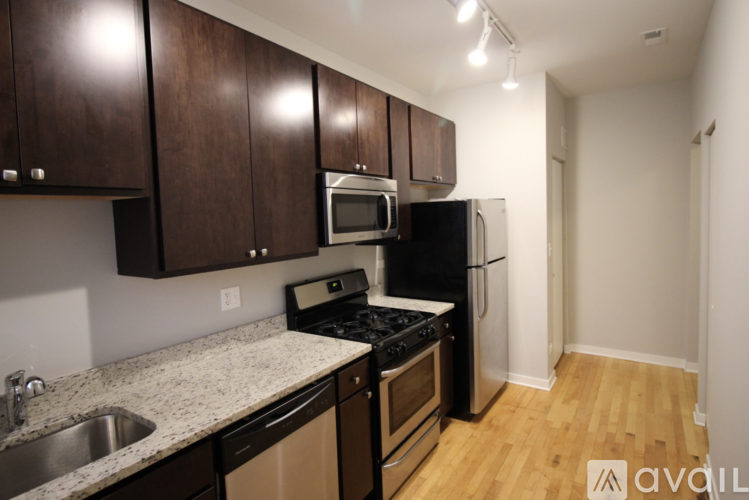 A kitchen with wooden cabinets and stainless steel appliances.