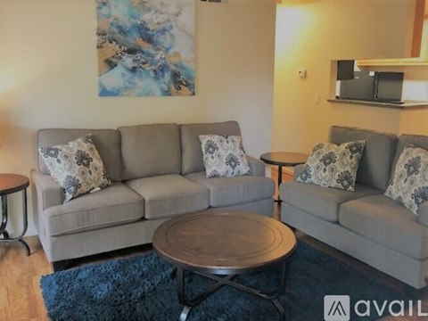 A living room with a grey couch and a coffee table.
