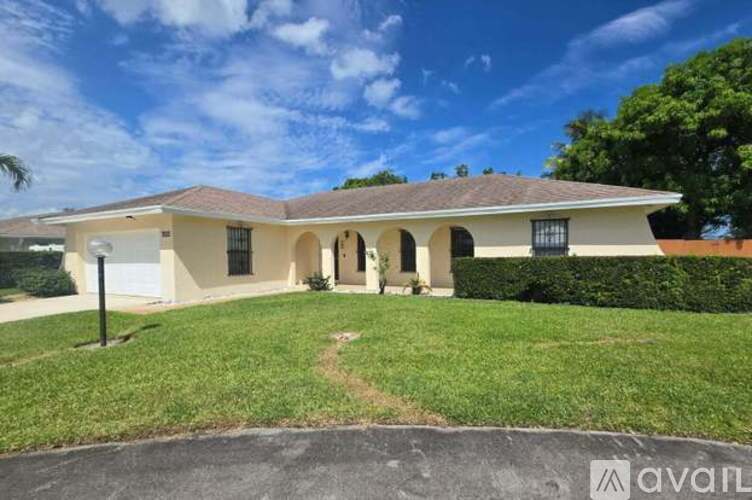 A house with a well-maintained lawn is for sale.