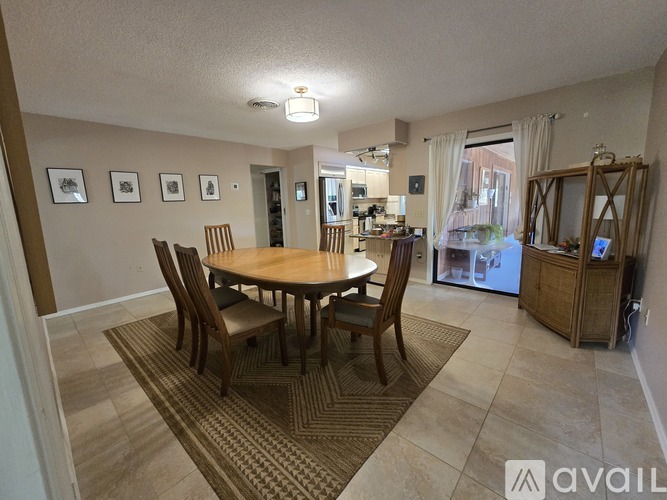 A dining room with a table and chairs.