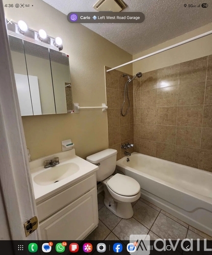 A bathroom with a toilet, sink, and bathtub.