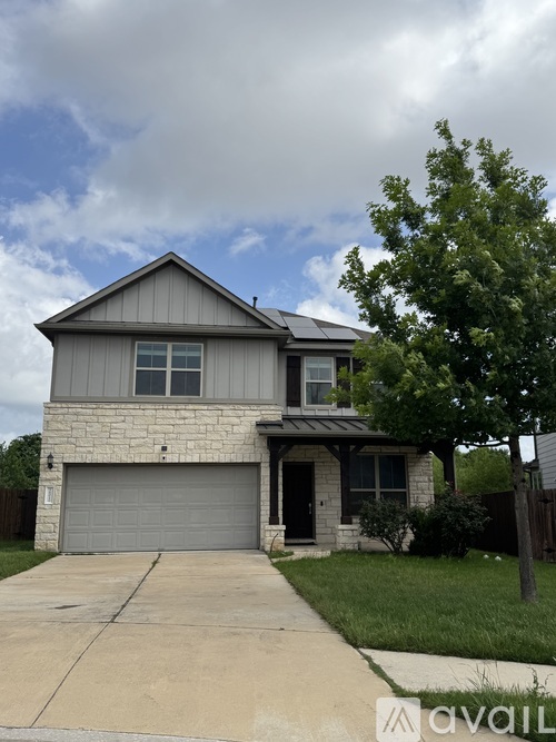 A two-story house with a garage is available for rent.
