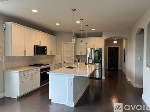 A modern kitchen with white cabinets and a central island.