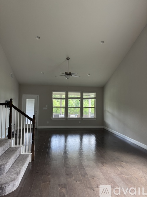 A spacious room with a staircase leading to a window.