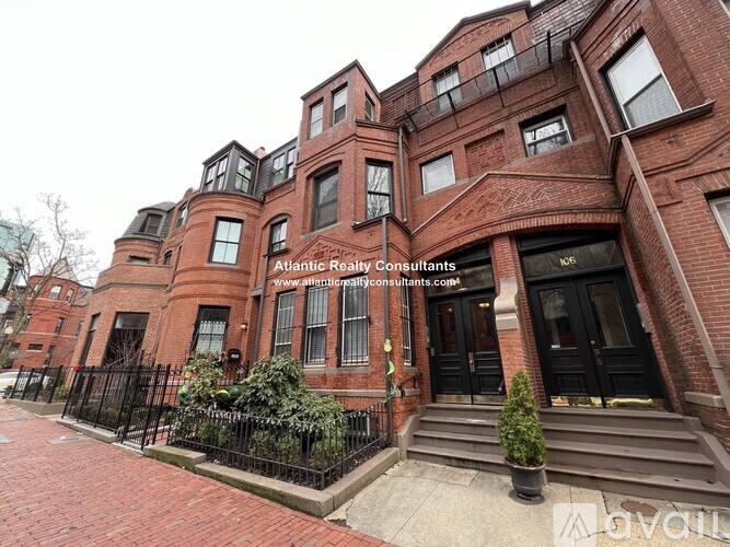 A red brick building with the sign Atlantic Realty Consultants on the front.