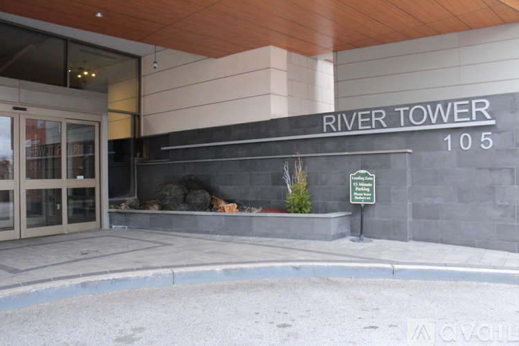 The entrance to the River Tower building with a sign that says "Available".