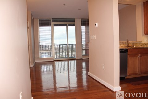 A kitchen area with a sink and a window overlooking the ocean.