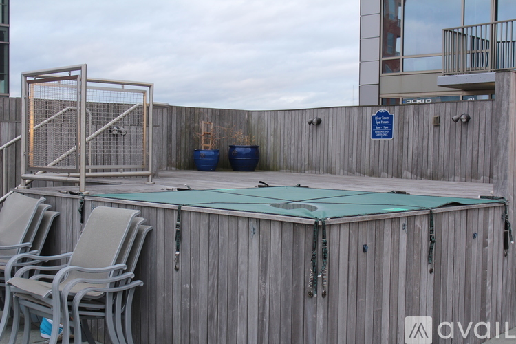 A pool area with chairs and a fence.