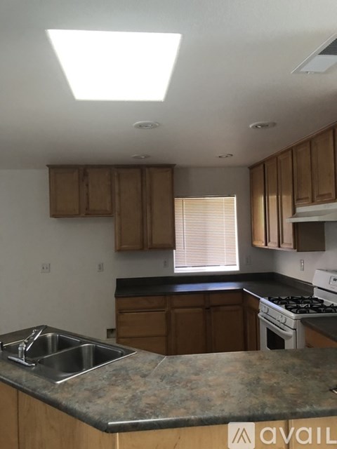 A kitchen with a sink and a stove.