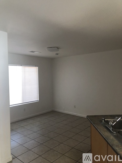 A kitchen area with a sink and a window.