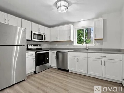 A kitchen with white cabinets and stainless steel appliances.