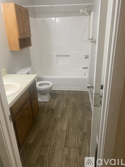 A bathroom with a toilet, sink, and bathtub.