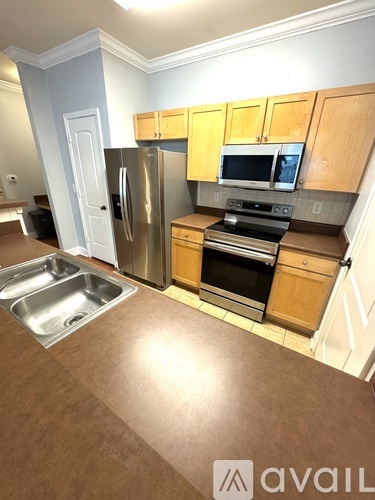 A kitchen with wooden cabinets and stainless steel appliances.