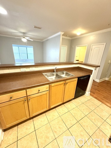 A kitchen with wooden cabinets and a sink.