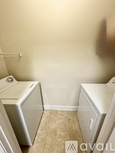 A bathroom with a toilet, sink, and a cabinet.